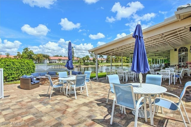 view of patio / terrace featuring a water view and outdoor dining space