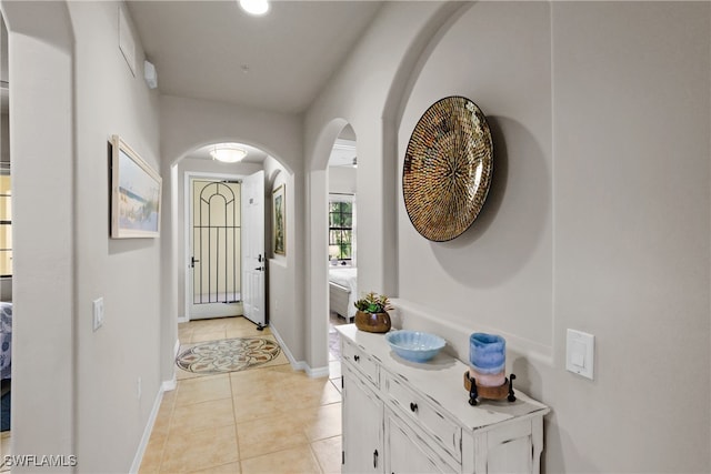 doorway to outside with light tile patterned floors