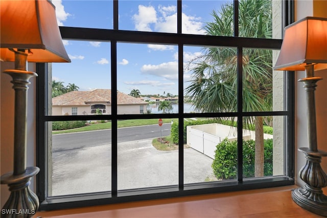 doorway to outside featuring a healthy amount of sunlight and a water view