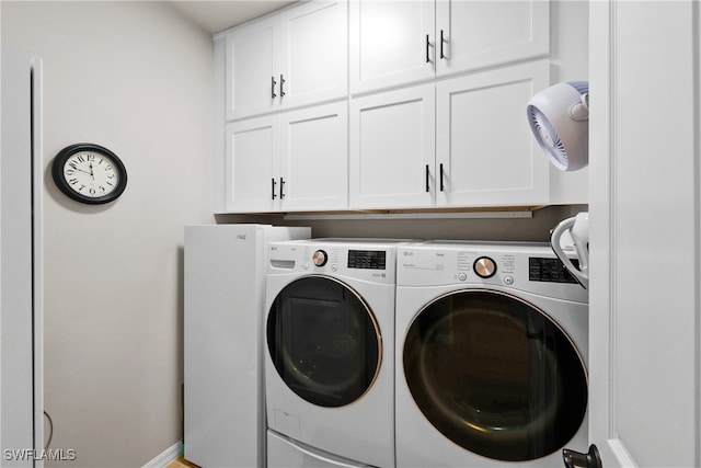 laundry room with cabinets and separate washer and dryer