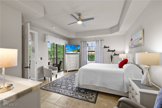 tiled bedroom with ceiling fan and access to exterior