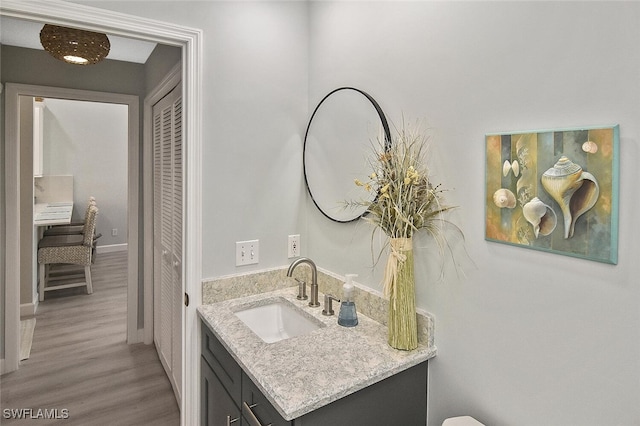 bathroom with vanity and hardwood / wood-style flooring