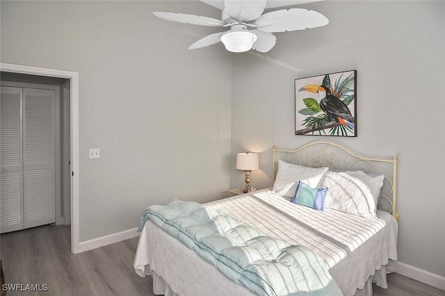 bedroom featuring ceiling fan, a closet, and hardwood / wood-style flooring