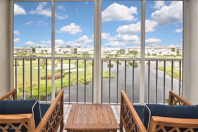 sunroom / solarium with plenty of natural light and a water view