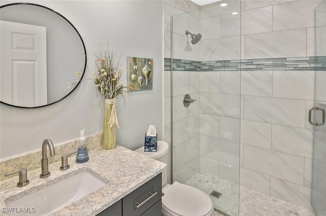 bathroom with vanity, toilet, and an enclosed shower