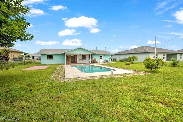 view of pool featuring a lawn and a patio