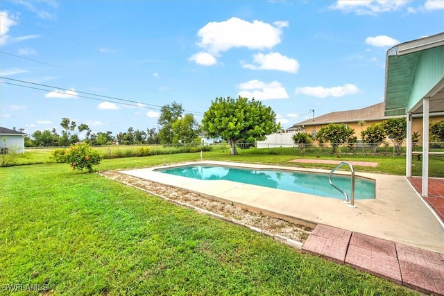 view of swimming pool featuring a patio and a yard