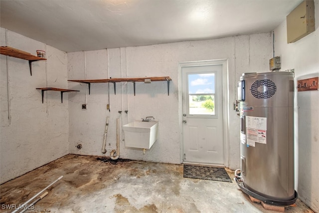 interior space featuring water heater, sink, and concrete floors