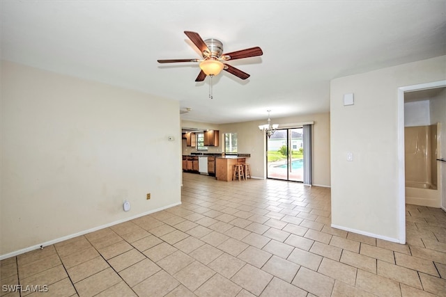 unfurnished living room featuring ceiling fan with notable chandelier and light tile patterned floors