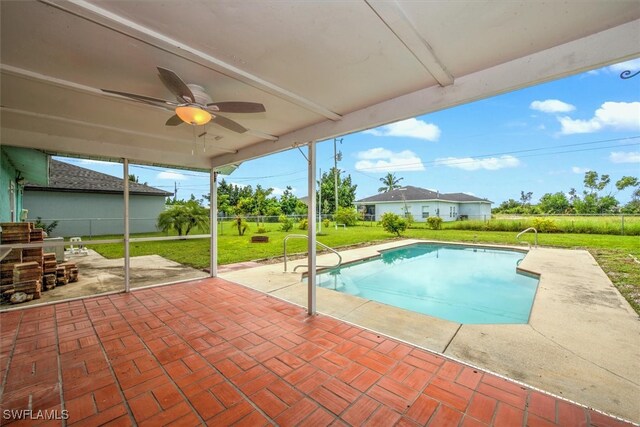 view of pool featuring a patio, ceiling fan, and a yard