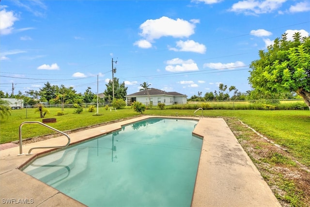 view of pool featuring a lawn