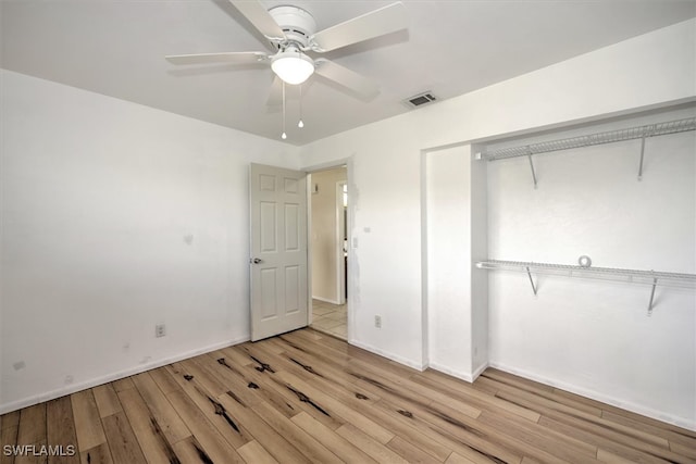 unfurnished bedroom featuring ceiling fan, a closet, and light hardwood / wood-style floors