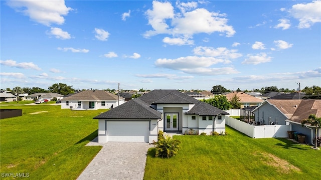 view of front facade with a garage and a front lawn