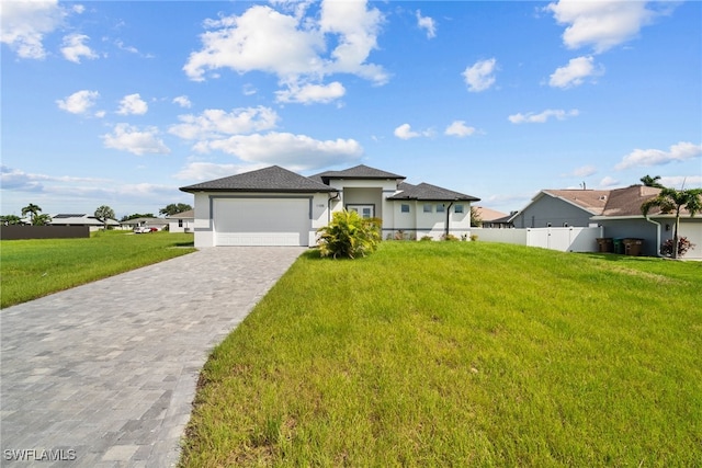 view of front of house featuring a front yard and a garage