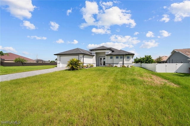 view of front of house featuring a front yard and a garage