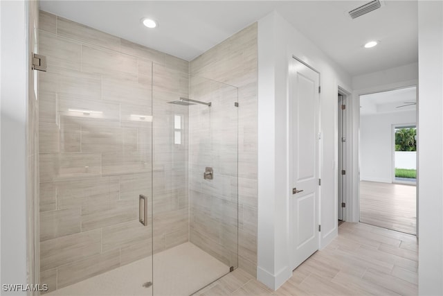 bathroom with a shower with shower door