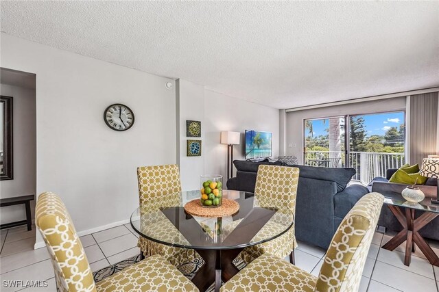 tiled dining area with a textured ceiling