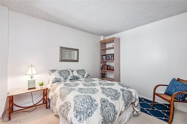 bedroom with a textured ceiling and carpet flooring