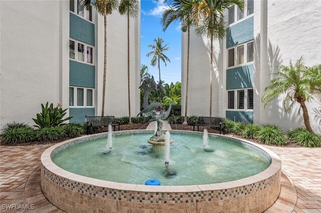 view of swimming pool with pool water feature