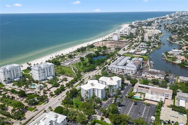 drone / aerial view with a water view and a beach view