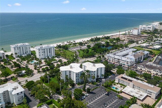 drone / aerial view featuring a view of the beach and a water view