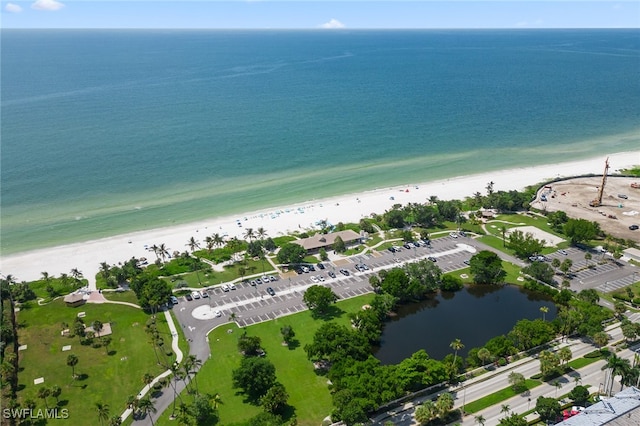 drone / aerial view featuring a water view and a view of the beach