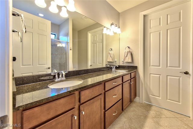 bathroom featuring walk in shower, vanity, and tile patterned flooring