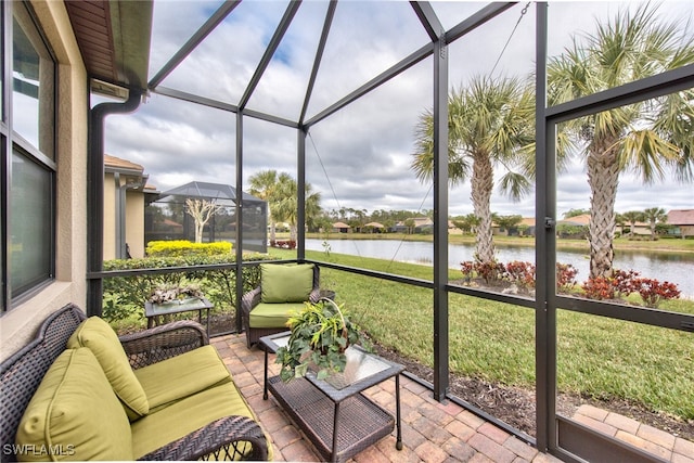 sunroom featuring a water view and plenty of natural light