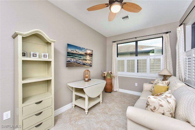 sitting room with ceiling fan and light tile patterned floors