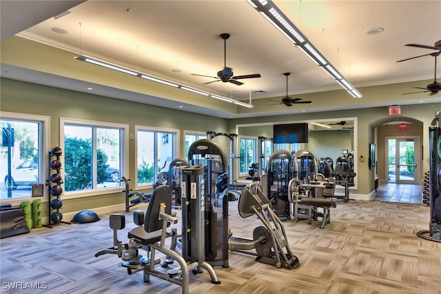 exercise room with ceiling fan and crown molding