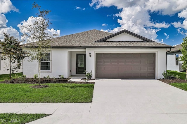 view of front of house featuring a front yard and a garage