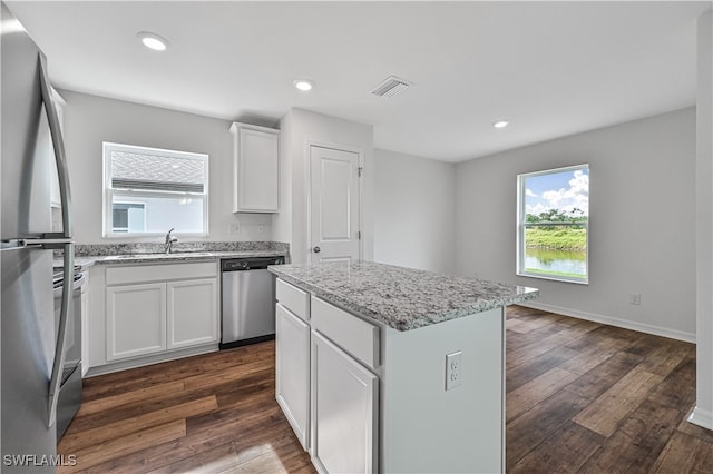 kitchen with a center island, dark hardwood / wood-style floors, sink, white cabinetry, and stainless steel appliances