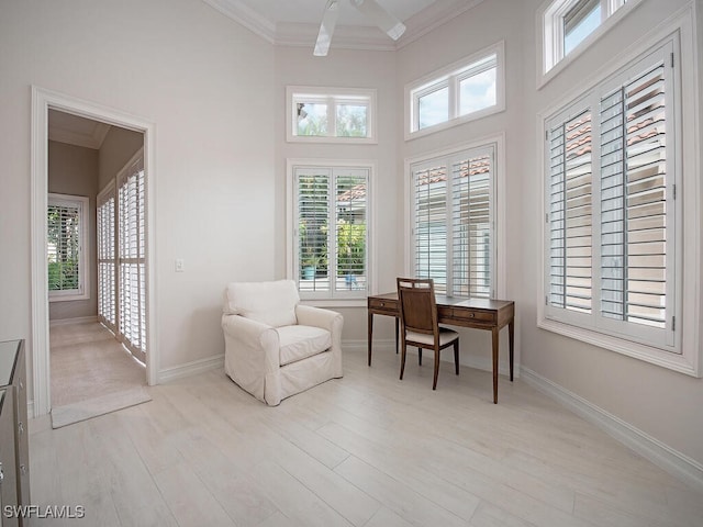 living area with crown molding, plenty of natural light, and light wood-type flooring