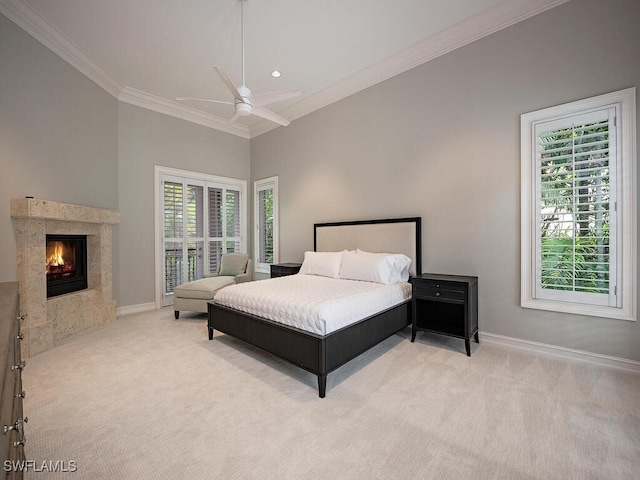 bedroom with ceiling fan, multiple windows, and light colored carpet