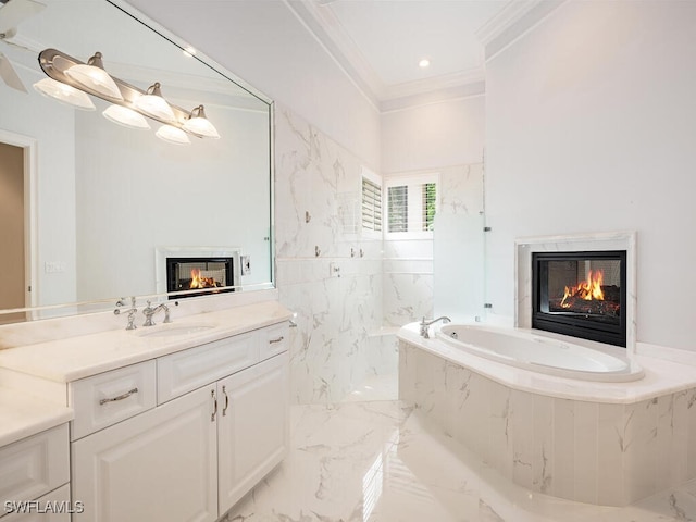 bathroom featuring vanity, ornamental molding, and tiled tub