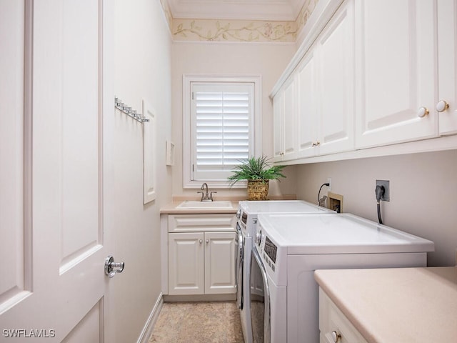 washroom featuring cabinets, ornamental molding, sink, and separate washer and dryer