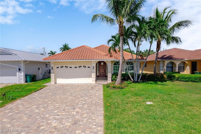 view of front of home with a front yard and a garage