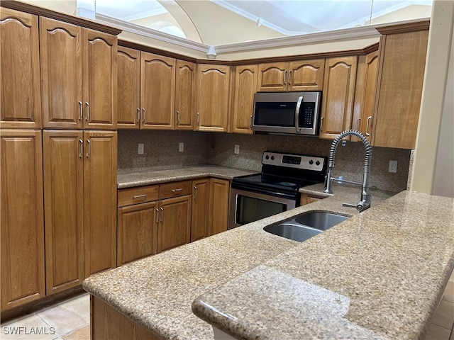 kitchen featuring light stone countertops, sink, backsplash, appliances with stainless steel finishes, and ornamental molding