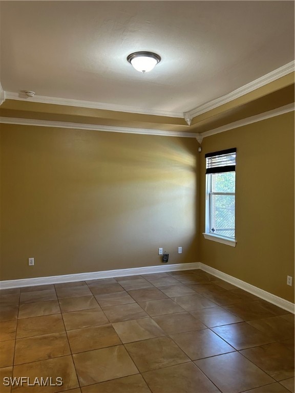 spare room with tile patterned flooring and ornamental molding