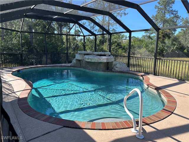 view of swimming pool featuring a patio area and a lanai