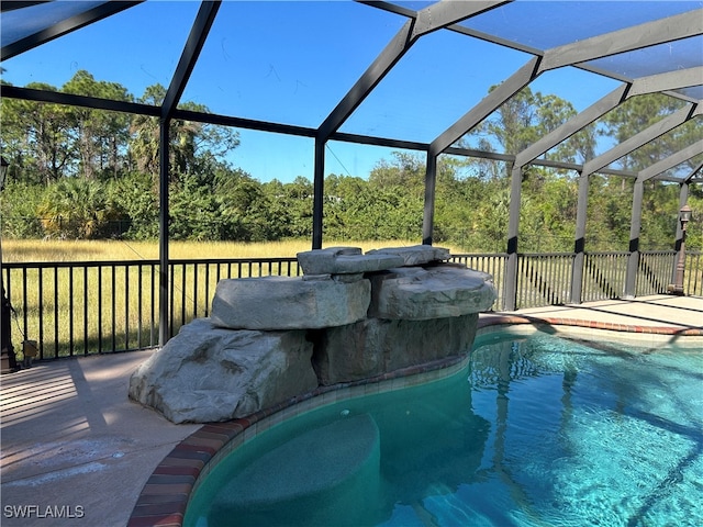 view of pool with glass enclosure