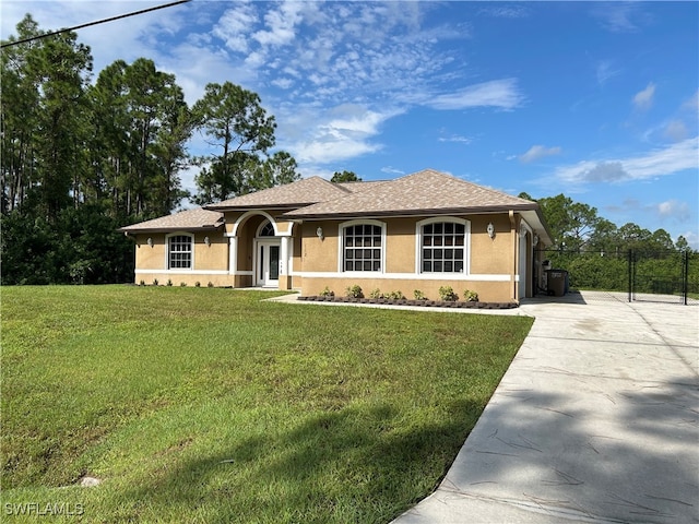 ranch-style home with a front lawn