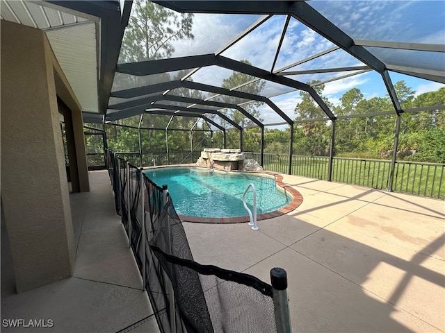 view of pool with pool water feature, a patio area, and a lanai