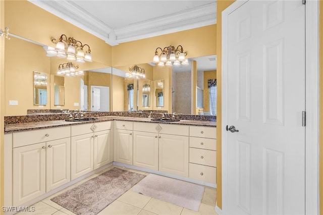 bathroom with crown molding, tile patterned flooring, and vanity