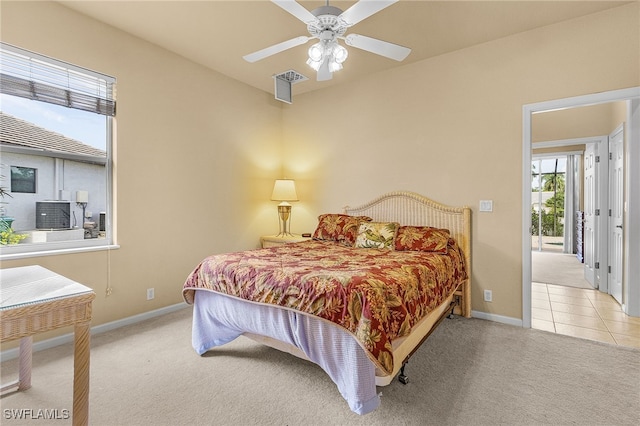 bedroom featuring light carpet and ceiling fan