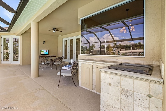 view of patio with french doors, glass enclosure, and ceiling fan