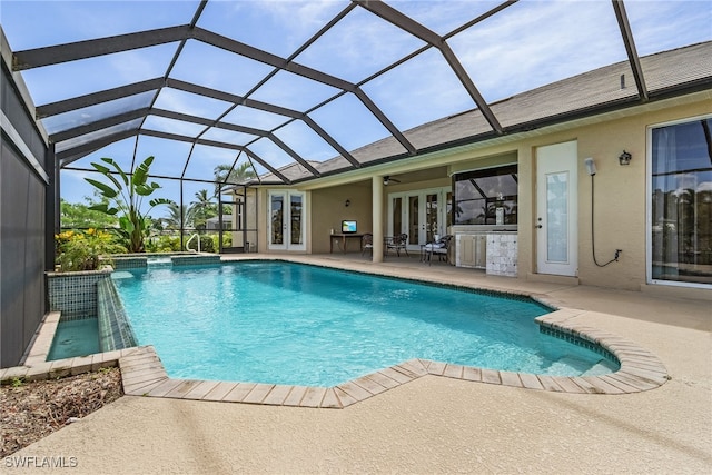 view of pool with ceiling fan, a lanai, a patio, and french doors