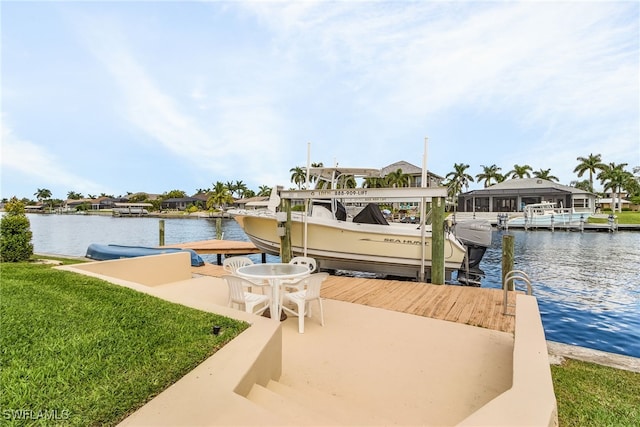 dock area featuring a water view and a lawn