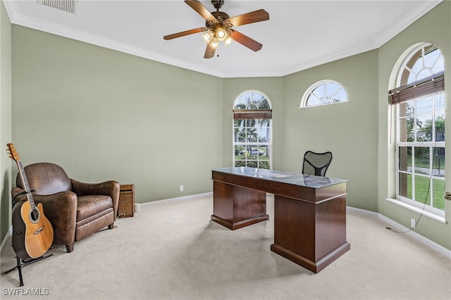 carpeted home office featuring a wealth of natural light, crown molding, and ceiling fan