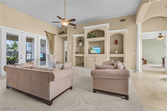 living room featuring decorative columns, built in shelves, french doors, and light tile patterned floors